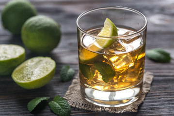 Glass of rum on the wooden background
