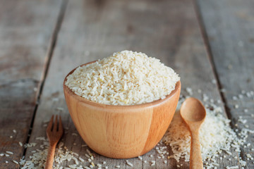 Rice and spoon on wooden.