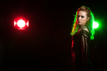 Attractive cosplay model in corset in studio photo with a red and green light from behind. Cosplay and subculture