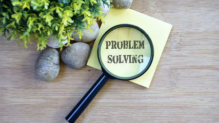 Ornamental trees, stones Small, magnifying glass, sticky note with text problem solving
