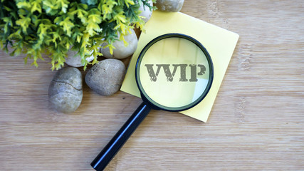 Ornamental trees, stones Small, magnifying glass, sticky note with text vvip