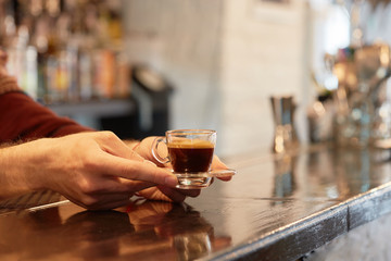 Female hand holding cup of coffee
