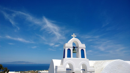 The white building in the town of Oia in Santorini, with beautiful views of the sea in the background