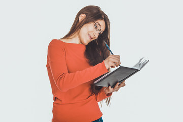 Female student writing in notebook.