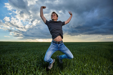 Teenager jumping for joy outdoor