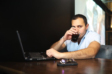 Armenian handsome man working behind laptop