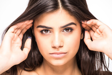 Fototapeta premium Beauty portrait. Beautiful spa woman touching her face. Perfect fresh skin isolated on white background. Pure beauty model. Youth and Skin Care Concept