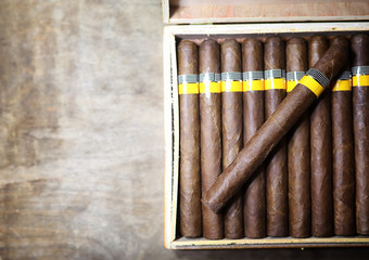 Large box of Cuban cigars on a wooden table