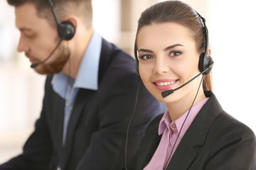 Young woman with headset working in office