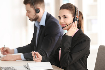 Young woman with headset working in office © Africa Studio