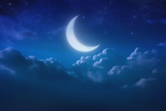 half blue moon behind cloudy on sky and star at night. Outdoors at night. lunar shine moonlight over cloud at nighttime with copy space background for headline text and graphic design.
