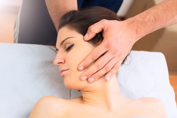 Professional massage at the neck of a woman
