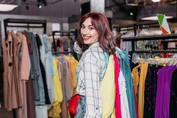 Naklejka na ściany i meble young hipster girl smiling in boutique, clothes shopping concept
