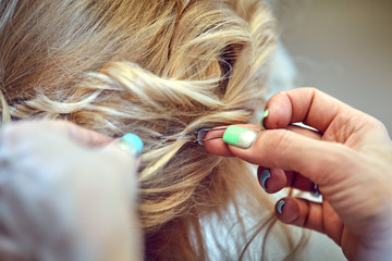 Hair styling in a beauty salon .