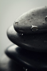Beautiful picture of Spa Hot Stones. Dark Background. Closeup. Wet Hot Stones.