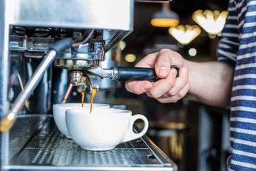 side view of barista preparing fresh coffee in cafe