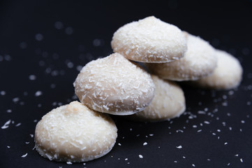 Cookies with cocos. Biscuits with cocos. Biscuits with white chocolate and cocos on black background. 
