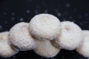 Cookies with cocos. Biscuits with cocos. Biscuits with white chocolate and cocos on black background. 