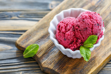 Balls of homemade ice cream of black currant.