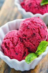 Homemade berry ice cream in a white ceramic cup.