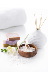 handmade soap, sea salt and towel isolated on white, spa treatment concept