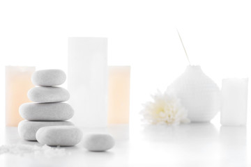 Fototapeta na wymiar Zen stones and candles isolated on white, spa treatment concept