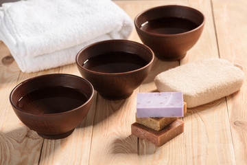 Close-up view of fresh clean water in three bowls on wooden table