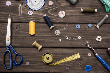 top view of set of various sewing supplies on wooden surface