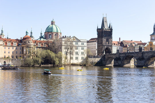The view from the river Vltava to Charles Bridge and old town bridge tower . The old town district . Prague , Czech Republic .