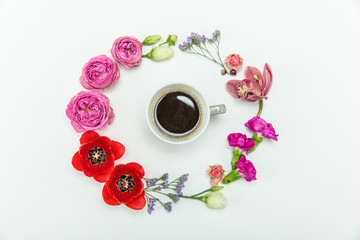 Fototapeta na wymiar Top view of beautiful various blooming flowers around cup of coffee isolated on white