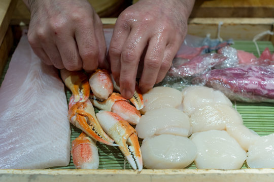 Steamed giant crabs, shell, fish raw prepare to make sushi in Japanese food. Select focus at hand of chef