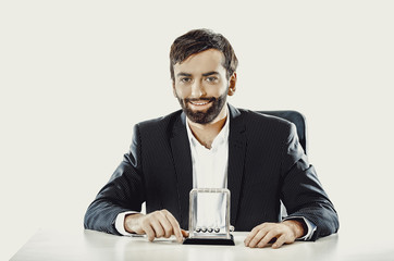 Man moving newton balls in office.