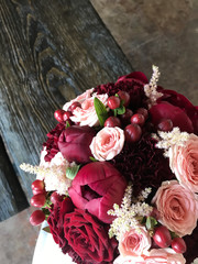red bridal bouquet in girls hand