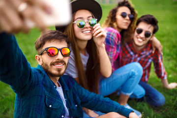 Group of friends enjoying party.people are making selfies .Everyone has a great mood. Summer time. 