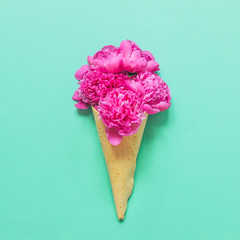 Ice cream cone with pink flowers and leaves.