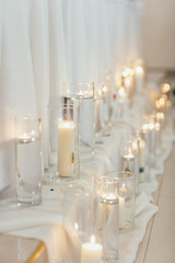 The candles standing near wedding table