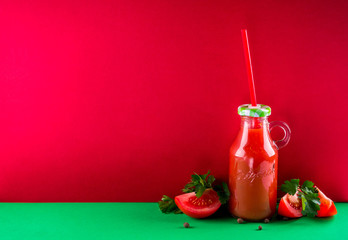 Tomato juice on red background