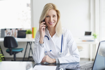Female doctor giving advise on telephone