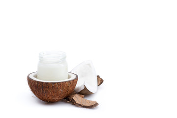ripe coconut and organic coconut oil in glass jar isolated on white
