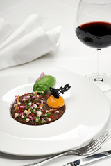 Veal tartar and wine in a restaurant