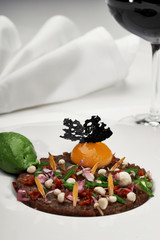 Veal tartar and wine in a restaurant
