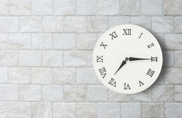 Fototapeta na wymiar Closeup white clock for decorate show a quarter past seven o'clock or 7:15 a.m. on old brick wall textured background with copy space in interior concept