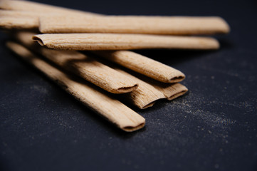 Close up creamy sticks biscuits. Delicious and tasty biscuits, cookies on black background.