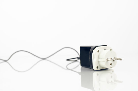 Electricity Charger With Adapter On It On White Background With Reflection