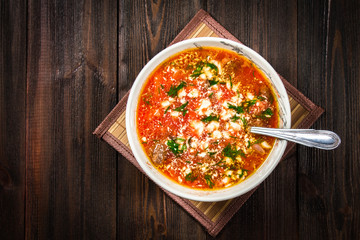 Traditional Ukrainian Russian vegetable borscht on the white wooden background. Top view