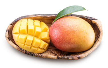 Obraz na płótnie Canvas Mango fruits and mango cubes in the wooden bowl.