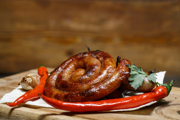 Assorted delicious grilled meat with vegetable over the coals on a wooden table