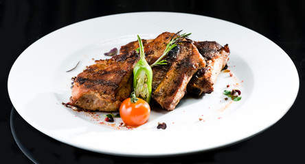 Grilled beef meat on a white plate