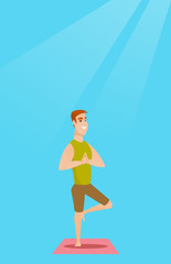 Young man practicing yoga tree pose.