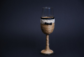 Wedding glasses for bride and groom on black background. 
Wedding glasses on black background with dry roses. Beautiful glasses. Glasses for groom and bride. Decoration glasses. Vintage.